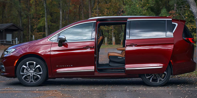 Red Chrysler Pacifica with sliding door open.